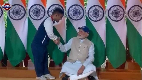 Javelin gold medalist Navdeep Singh presents a special cap to PM Modi.
