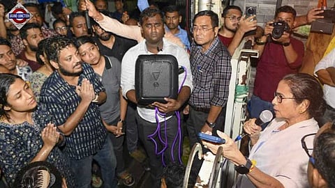 Mamata Banerjee speaks with the protesting doctors outside her home amid rain in Kolkata on Saturday.