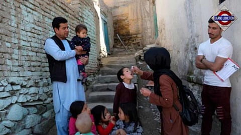 Shabana Maani, gives a polio vaccination to a child in the old part of Kabul, Afghanistan, Monday, March 29, 2021.