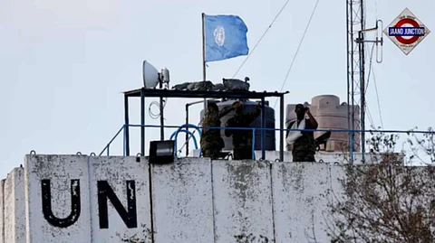 Members of the United Nations peacekeepers (UNIFIL) look at the Lebanese-Israeli border, as they stand on the roof of a watch tower in southern Lebanon.