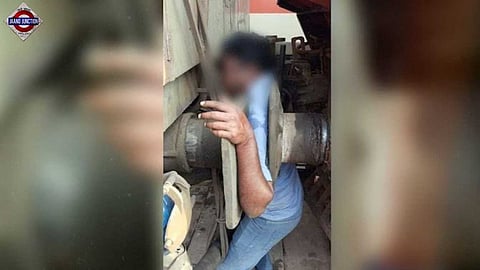 Railway employee trapped between engine and power car.