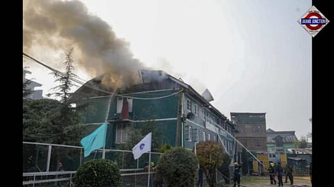 Smoke billowing from the top floor of the Muslim Public High School at Rajbagh in Srinagar as firefighters try to douse the fire on Thursday afternoon.