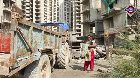 A construction worker with her child at an under-construction site, in Noida extension, Saturday, October 5, 2024.