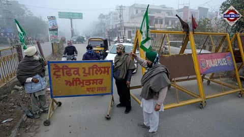 Farmers block a road during the statewide 'bandh' called as part their ongoing protest in Amritsar.