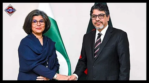 Bangladesh Foreign Secretary Md Jashim Uddin, right, shakes hands with Pakistan Foreign Secretary Amna Baloch.