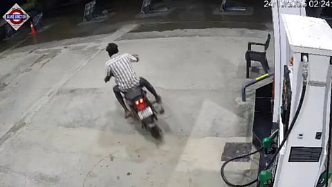 The biker seen riding away from a fuel dispenser. (Screengrab)