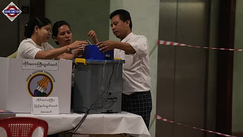 Election volunteers prepare to open a polling station Sunday, Dec. 28, 2025, in Yangon, Myanmar.