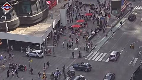 People run for their lives as multiple rounds of gunfire are heard in New York's Times Square.