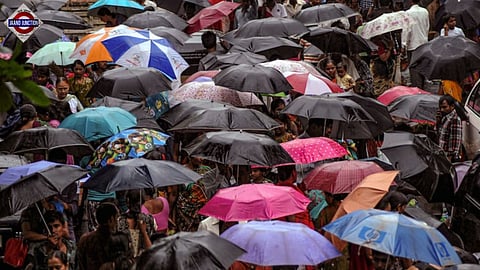 People with umbrellas crowd a street amid rain.