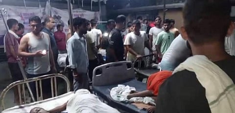 People gather at a local hopital after a boat capsized in the Ganga river, with several people feared drowned, in Bihar's Vaishali district on October 13, 2026.