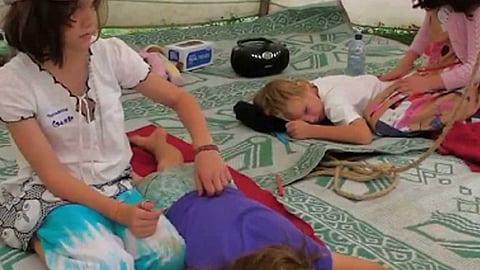 women doing body massage to the children