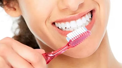 Girl brushing her teeth