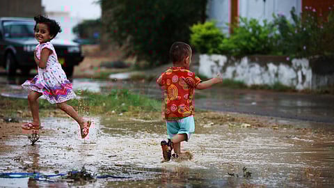 Children play in the puddle