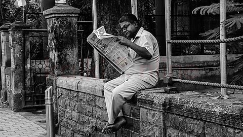 Old man reading a newspaper