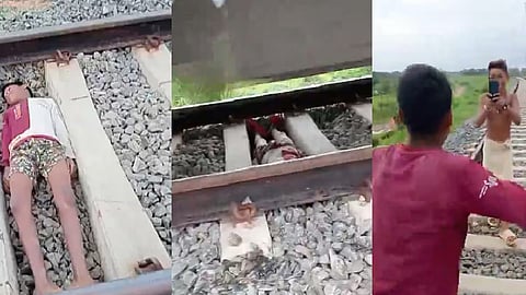 Two boys making reels on rail tracks