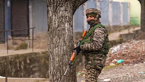 A security personnel stands guard near the site of the encounter