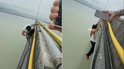Man Hangs Off Bridge