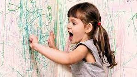 Child writing on the wall