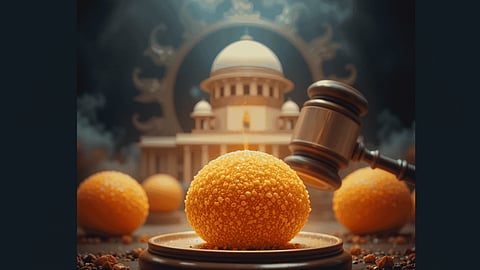 A gavel hovers above an orange sphere on a stand, surrounded by similar spheres