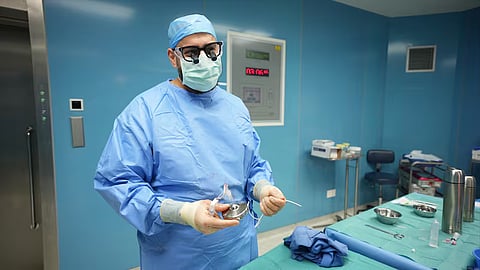 Dr Mohammad Adileh holding the implanted HAIP