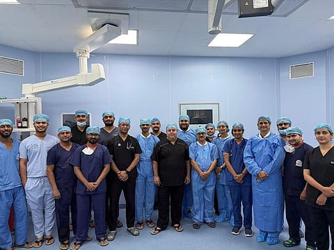 Surgeons and staff pose after complex pediatric kidney surgery