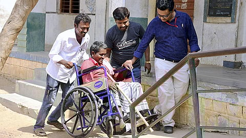 Senior citizens vote enthusiastically, helped by wheelchair