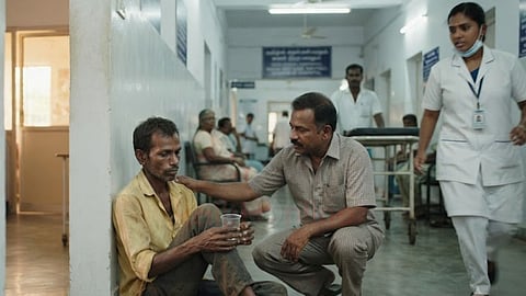 A sick, poor man sits in hospital