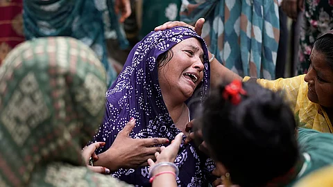 A relative of a victim of the Air India plane crash is comforted as she breaks down at a hospital in Ahmedabad, India, Friday, June 13, 2025.