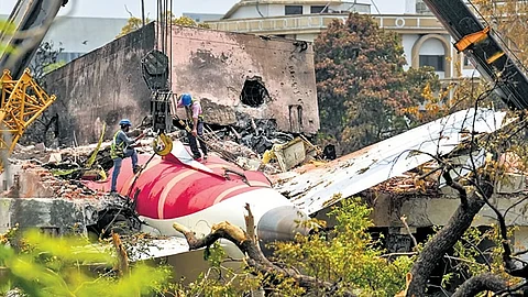 Cranes clearing the debris of the crashed Air India plane