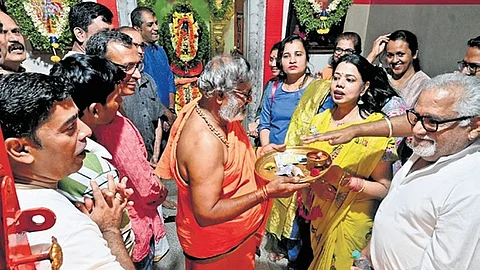 Residents of Holiday Village Road perform puja