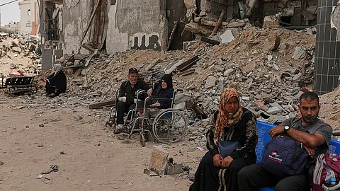 Kidney patients sit amid the destruction caused by the Israeli army at Shifa Hospital compound in Gaza City on Tuesday.
