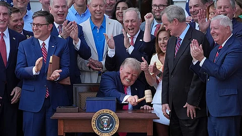 President Donald Trump bangs a gavel presented to him by House Speaker Mike Johnson of La.