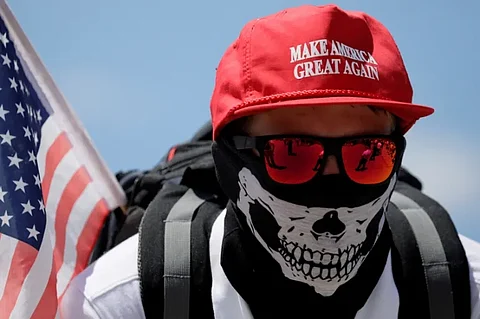 A demonstrator in a 'Make America Great Again' hat listens to speeches as 'white nationalists', 'white supremacists' and 'alt-right' activists gather in Washington in June 2017.