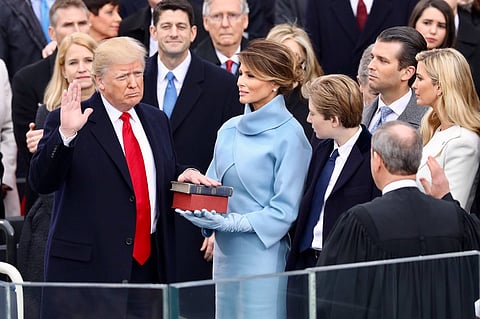 Trump takes the oath of office administered by Chief Justice John G. Roberts Jr. at the Capitol, January 20, 2017.