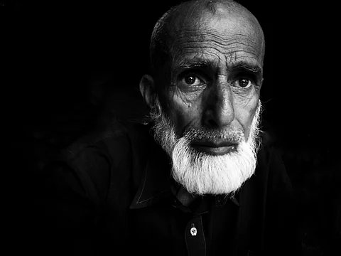 Bashir Ahmad Bakerwal rests in his make-shift tent as his wife, Haleema, worries about their fading way of life amid vanishing grazing lands.