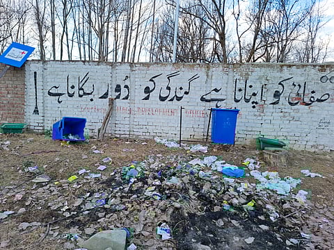 A powerful message promoting cleanliness "Safai ko apnana hai, gandagi ko door bhagana hai" (Cleanliness should be adopted, and waste should be eradicated) is painted on the boundary wall of a hospital in Hadipora Rafiabad. However, the reality contradicts the words, as broken dustbins and scattered garbage lie in the open, turning the site into an eyesore.