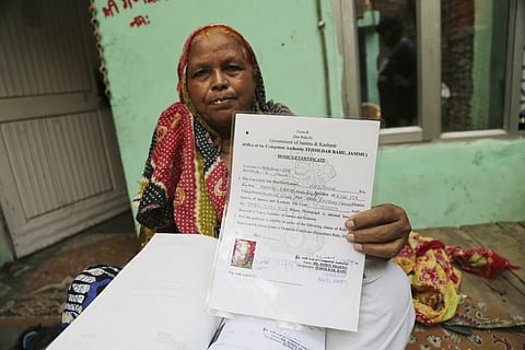 A woman in Jammu showing her newly issued Domicile Certificate issued by the government in 2020, a year after reading down of Article 370 and 35A of Indian Constitution by BJP-government in New Delhi.