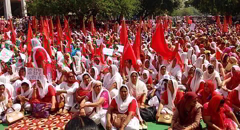 Anganwadi workers holding a protest rally seeking regularisation and higher wages in India.