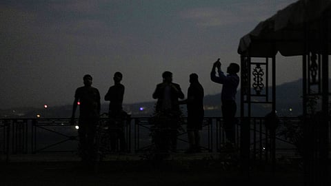 People watching India's air defence system during a blackout in Jammu on Friday.