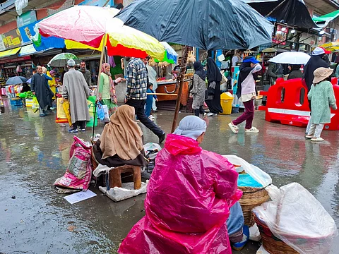 Lentil sellers wait patiently along the roadside during the rains, their colorful packets of dal neatly arranged, hoping for buyers in Srinagar, Kashmir.