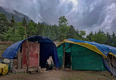 Khalida Begum, 27, daughter of Anwar Begum, sits silently outside her family’s temporary tent on June 1, 2025. She stares into the distance, her hands resting on her knees, as the family struggles to understand what has happened.
