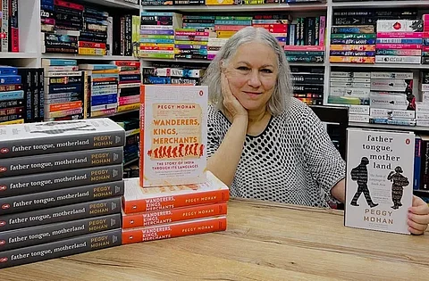 The author Peggy Mohan with her book, "Father Tongue, motherland" at a book store.