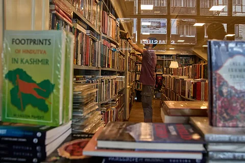 A Kashmiri man looks at a book in a bookstore in Srinagar, Kashmir, Thursday, August 7, 2025.