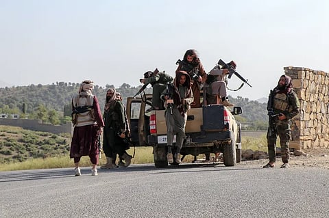 Taliban security personnel patrol a road in Zazai Maidan district of Khost province near the Afghanistan-Pakistan border on Sunday, October 12, 2025.