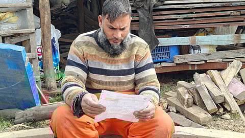 Sabzar Ahmad Dar, a resident of Turka-Tachloo, goes through his first electricity bill following the installation of a smart meter in Anantnag district of outh Kashmir.
