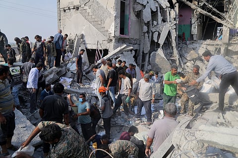 Rescuers and residents searching through the rubble of the Minab girls' elementary school, destroyed by the United States on February 28, 2026.