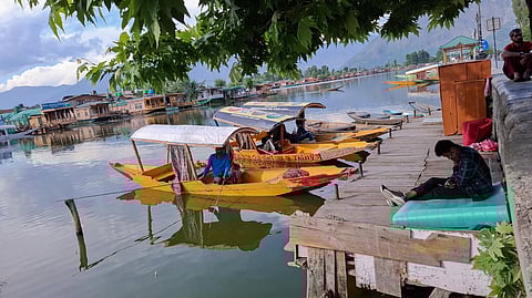 Ghat No. 4, Dalgate, Srinagar, May 25, 2025. With no tourists in sight, shikara operators pass time on their phones or go fishing, waiting for work that isn’t coming. Image is representational.