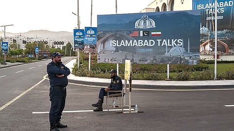 Pakistani security personnel stand guard outside the Jinnah Convention Centre, where international media have gathered to cover talks between US and Iranian officials, taking place in the nearby Serena Hotel, on April 11, 2026 in Islamabad.