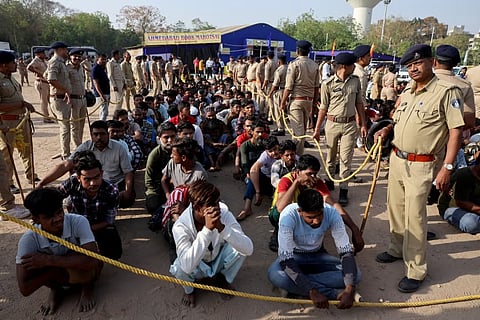 Police officers detain alleged undocumented Bangladeshi nationals after they were arrested during raids in Ahmedabad, India, April 26, 2025.