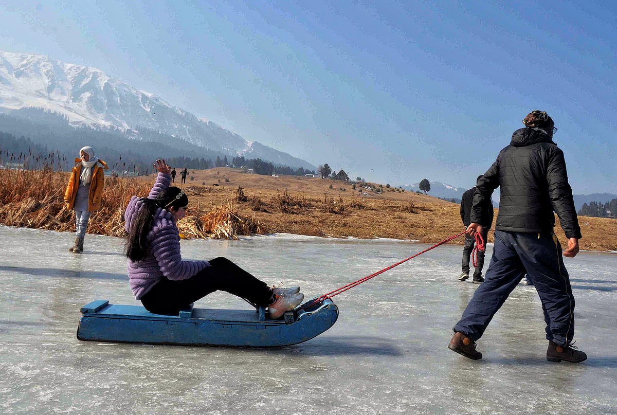 Tourists enjoying sledging on snow in Gulmarg, Kashmir during winters in 2024.